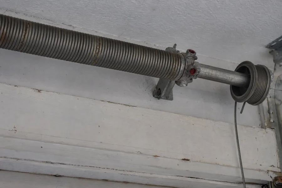 Torsion spring, shaft and cable drum above a garage door in Atlanta, GA