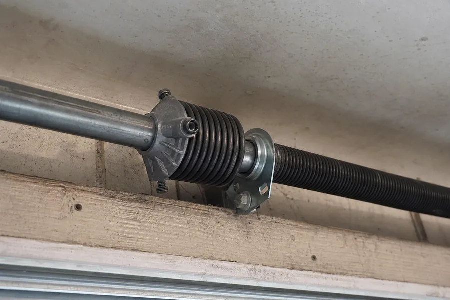 Torsion spring, winding cone and center bearing above a garage door in Atlanta, GA